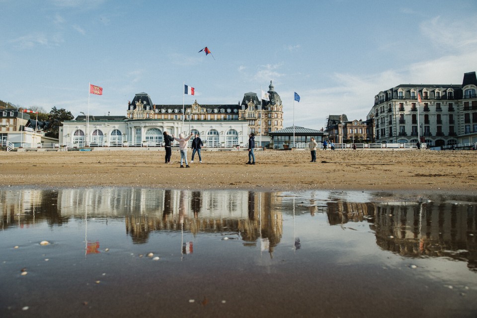 Des enfants font voler un cerf-volant sur la plage de Houlgate devant le casino Belle Époque.